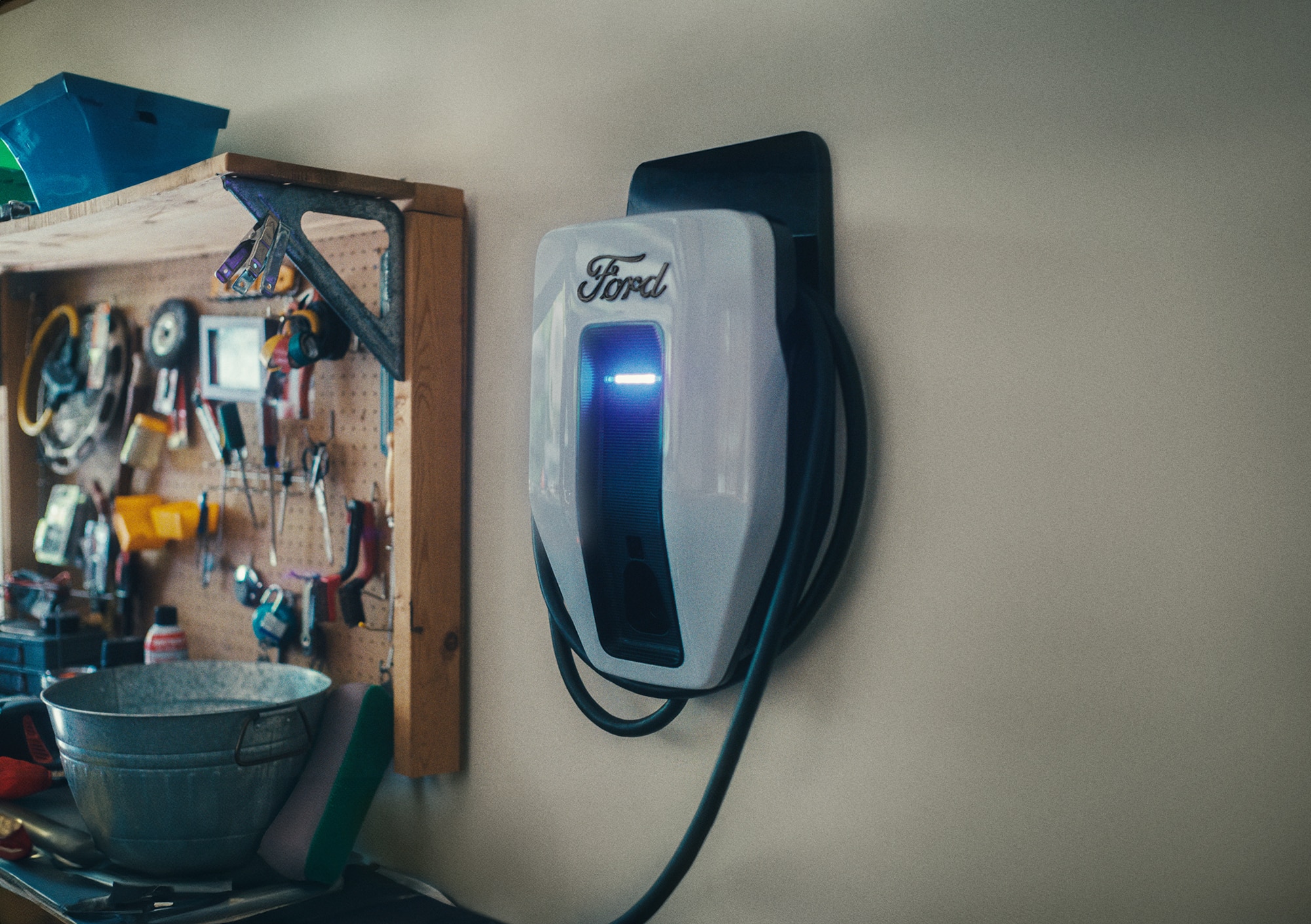 A Ford electric vehicle charger shown in a home garage